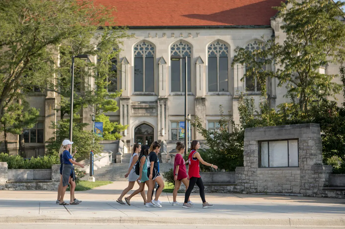Students walking past Watson Library on the University of Kansas campus in Lawrence, KS