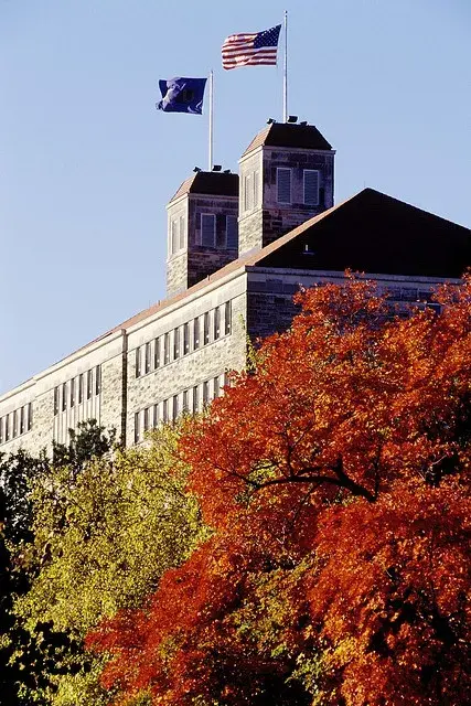 Fraser Hall at the University of Kansas above fall foliage in Lawrence, KS