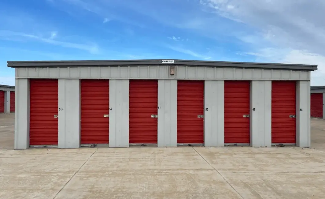 Row of drive-up storage units with red roll-up doors at Free State Storage in Lawrence, KS